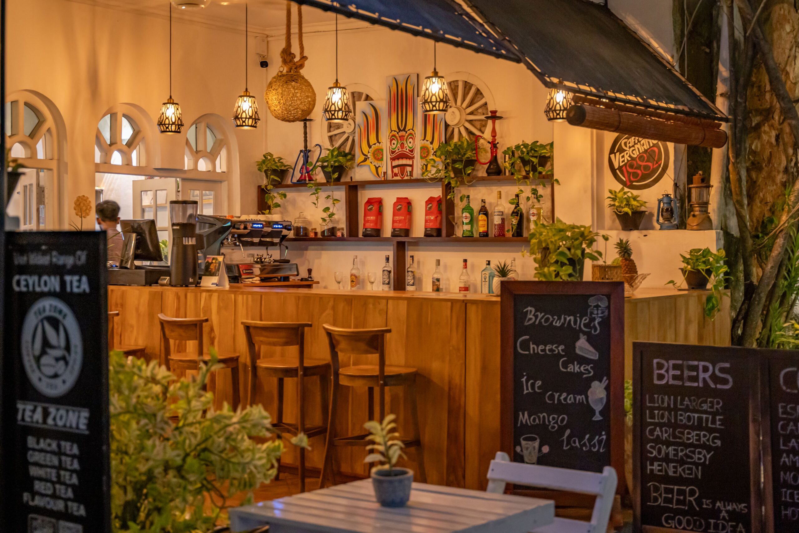 Inviting bar with wooden furniture and vibrant decor in Galle, Sri Lanka. Perfect for a cozy evening.
